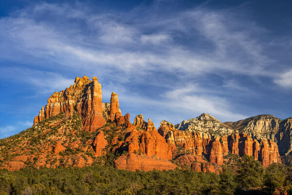 Sedona lanscape scene of a panoramic view of a wide red rock formation at sunset