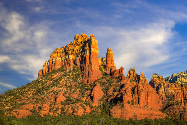 Sedona lanscape scene of a tall and majestic red rock formation in the soft evening light