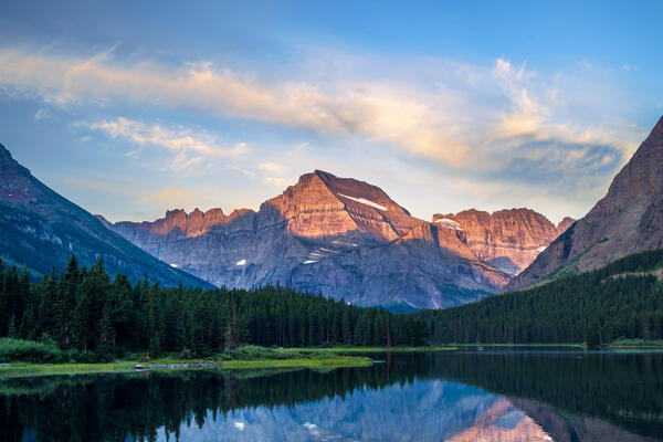 sunrise color in the sky above mount gould in glacier national park
