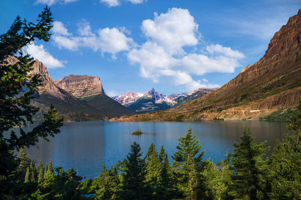 view of st mary lake with wild goose island surrounded by mountains in glacier national park
