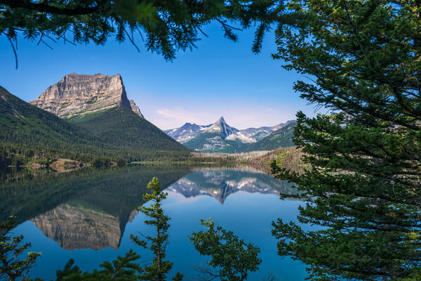 view of mountains behind st mary lake at sun point in glacier national park
