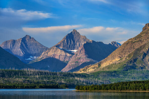 early light on mountains behind St Mary lake in glacier national park