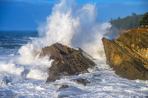 Oregon Coast landscape scene of huge storm waves colliding with the rocky coast at shore acres state park