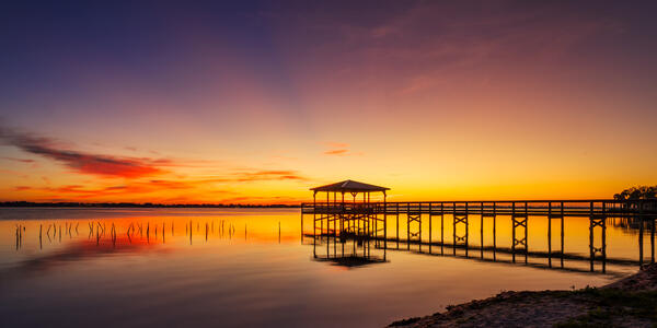 Florida landscape scene of a beautiful sunrise over a small dock on the Intercoastal Waterway