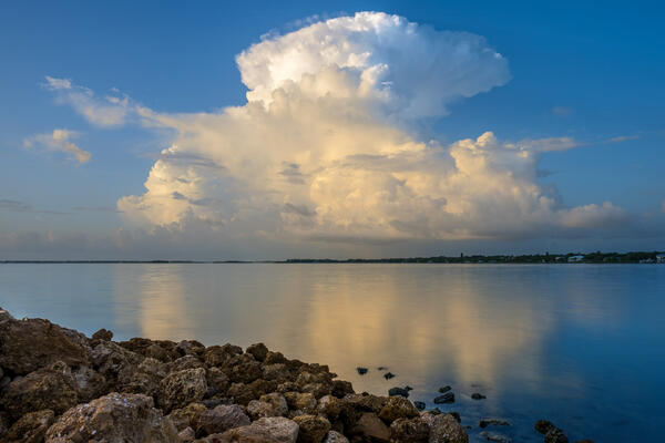 Florida landscape scene of an exploding cloud at sunrise over the calm waters of the Intercoastal Waterway