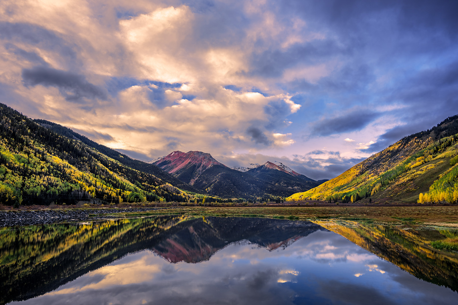 Crystal Colors Colorado mountains with fall colors reflecting in Crystal Lake beneath a colorful sky