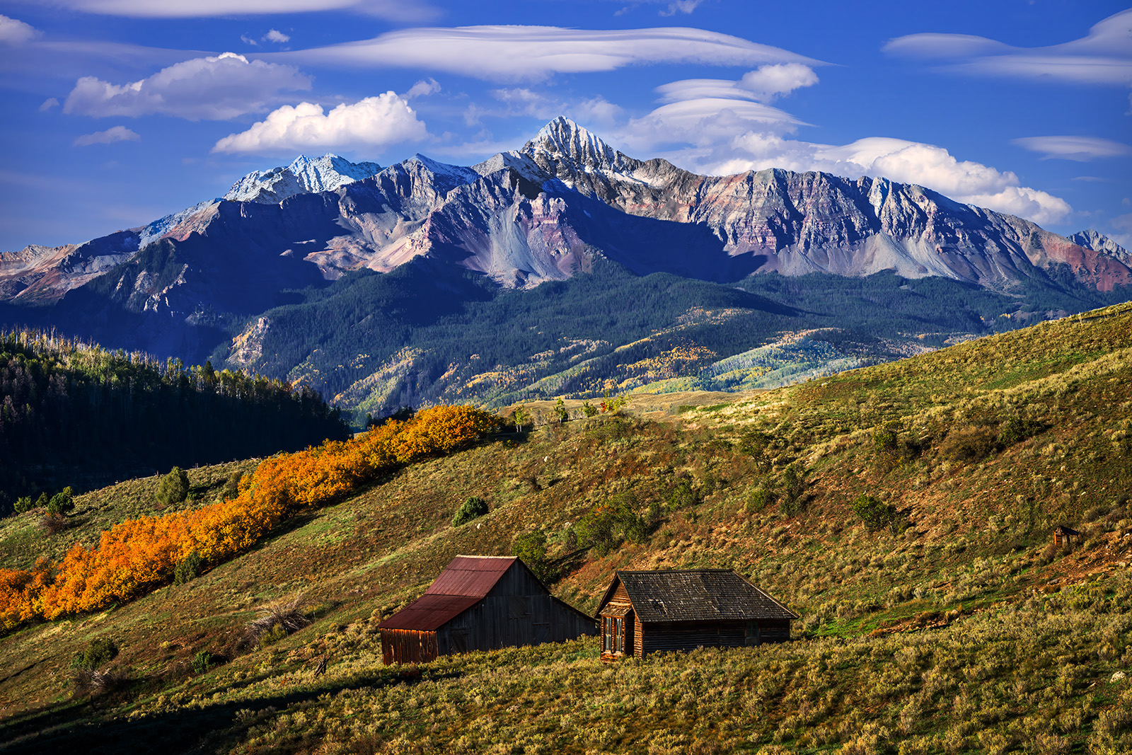 Mountain Cabins landscape view of two mountain cabins with a large mountain in the background