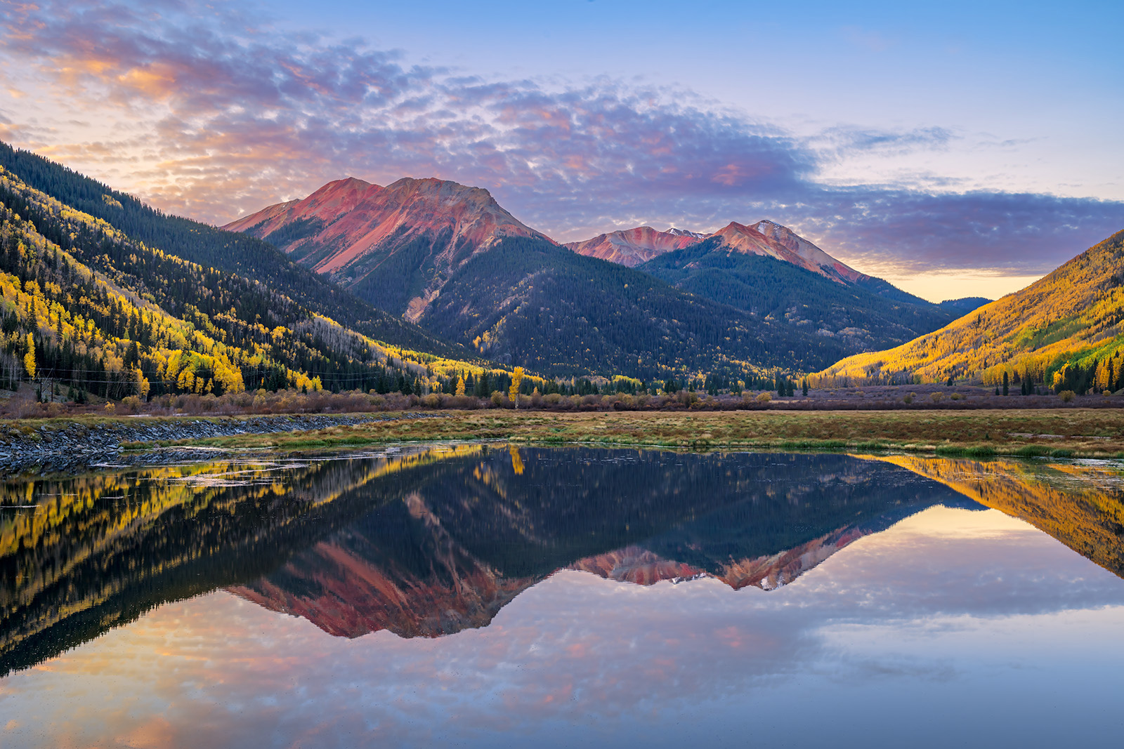 Crystal Blue Reflection Red Mountain and fall colors reflecting in Crystal Lake at sunrise