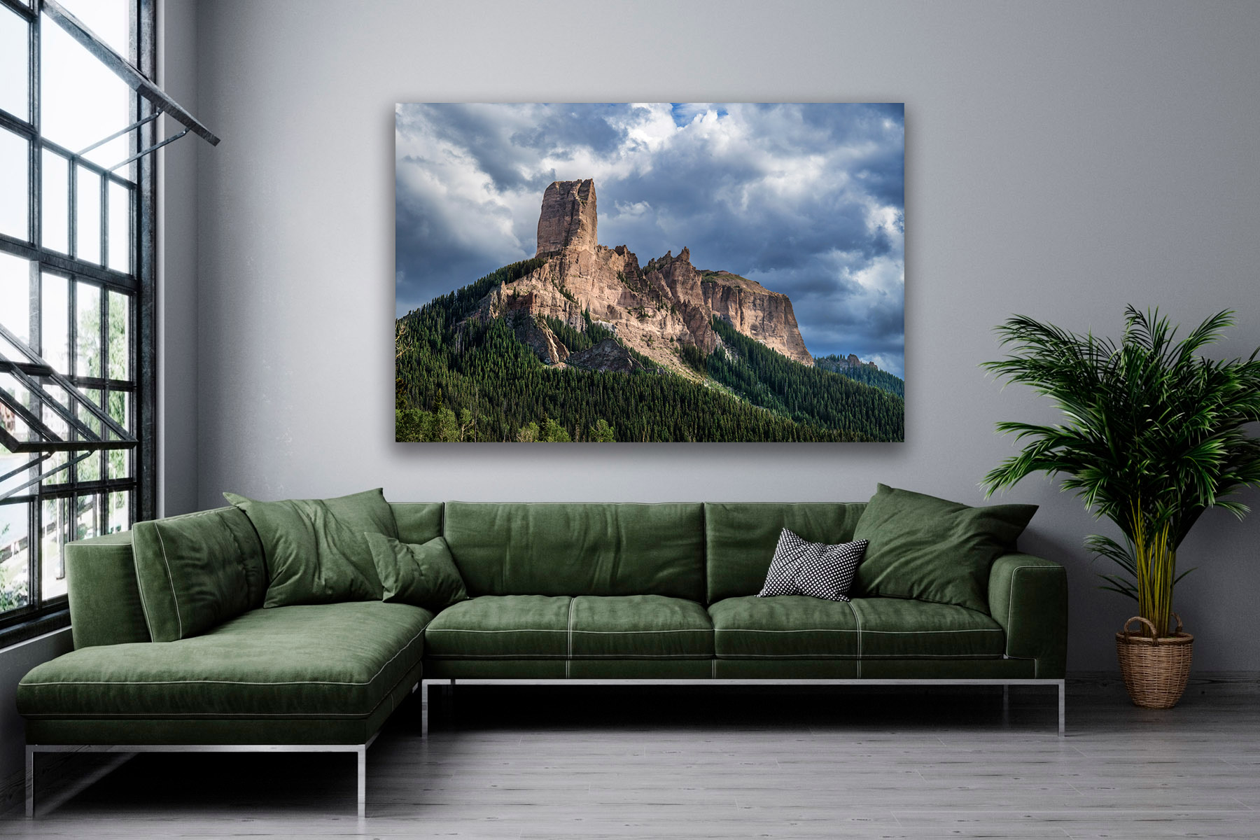 a closeup view of Chimney Rock and storm clouds as a print on a living room wall