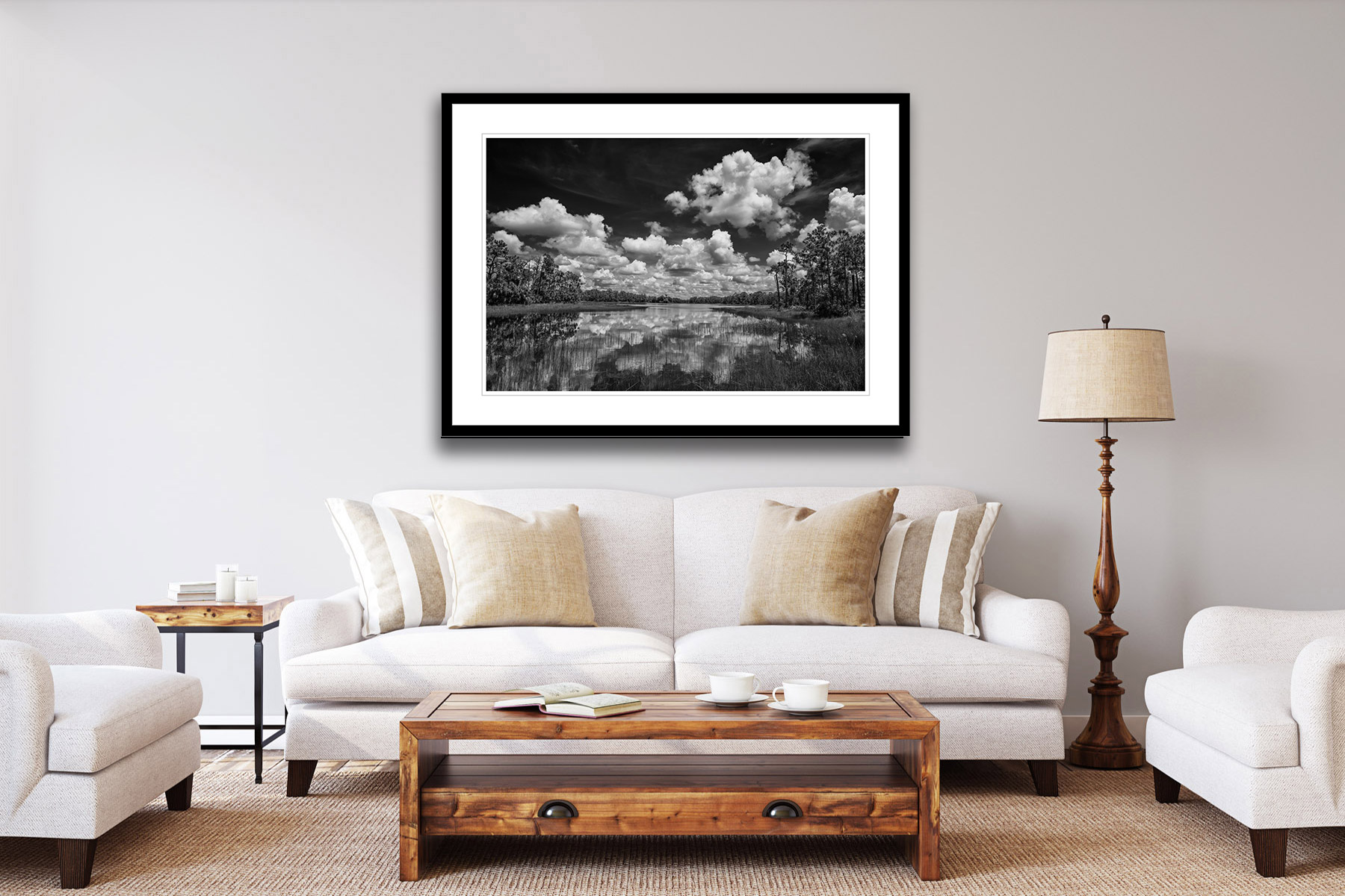 black and white view of clouds reflecting in a lake as a print on a wall