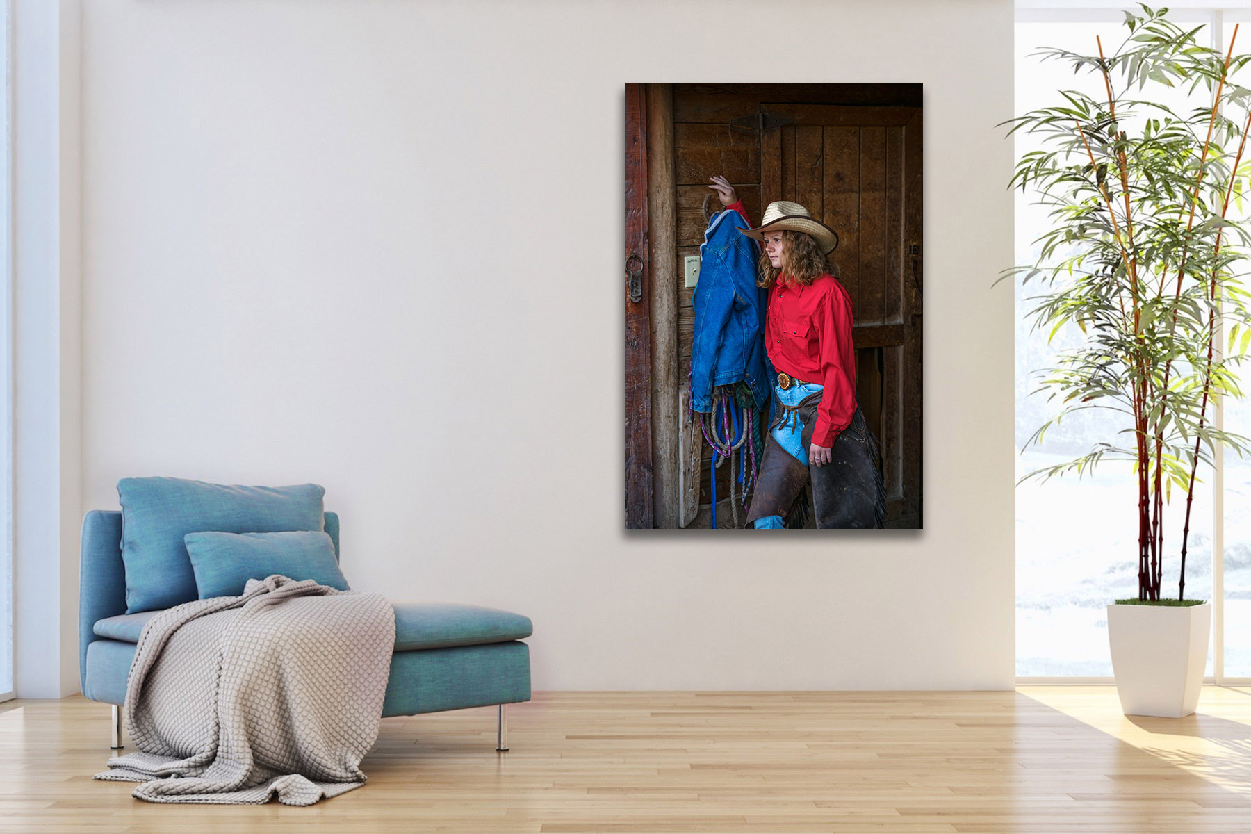 Cowgirl standing by the barn as a fine art photo print on the wall